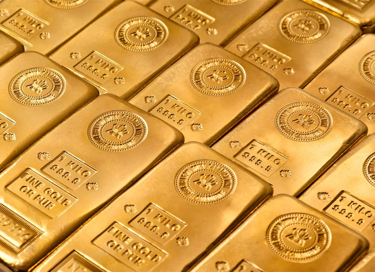 Royal Canadian Mint one-kilogram gold bars, photographed together in warm golden light