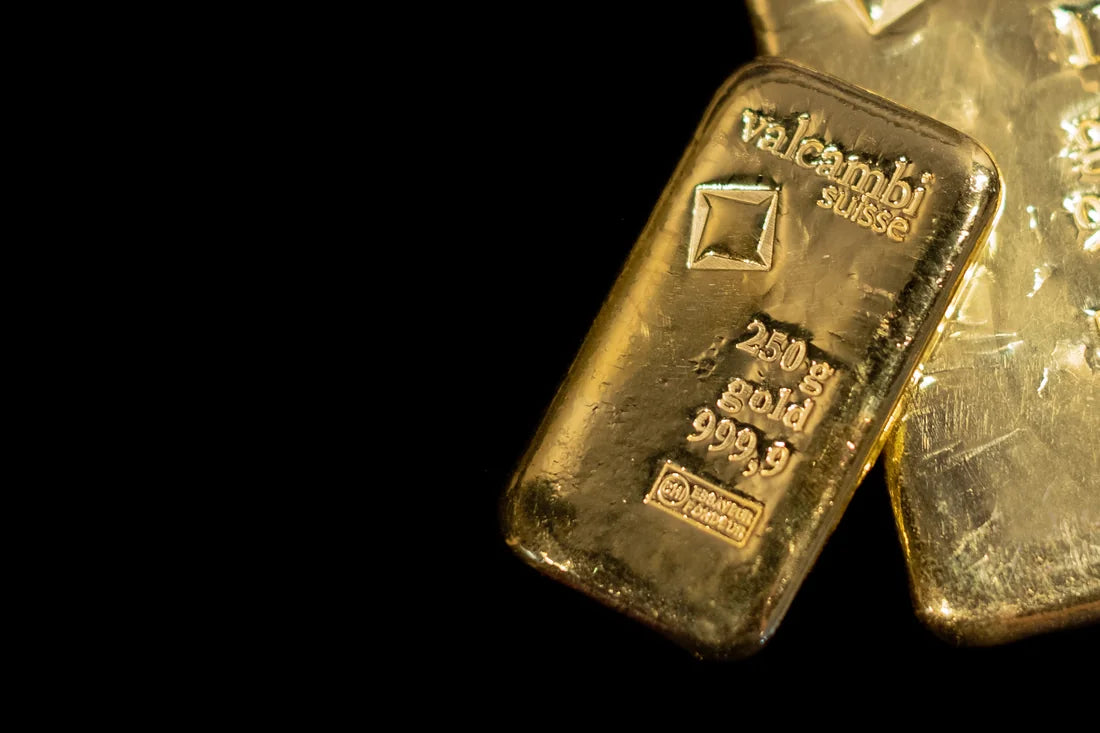 Valcambi Suisse cast gold bars against a dramatic dark background